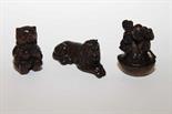 THREE CARVED JAPANESE WOODEN NETSUKES,
one of a recumbent lion, the other a monkey and one of a