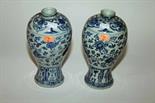 A PAIR OF CHINESE BLUE AND WHITE BALUSTER SHAPED VASES, 
each decorated with scrolling foliage, 9.