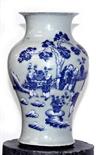 A CHINESE BALUSTER SHAPED AND MOULDED CELADON VASE, 
probably 18th century, decorated in blue and