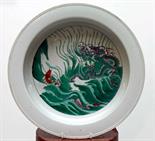 A CHINESE PORCELAIN FAMILLE VERTE BASIN, 
decorated with dragon above waves and fish below, 15" (