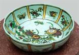 A CHINESE TURQUOISE GROUND LOTUS FORM LOBED DISH,
decorated with flowers and insects, bares a six-