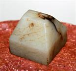 A SQUARE WHITE AND SPECKLED JADE PENDANT SEAL, 
1.5in (4cm). (1)