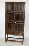 A CHINESE FOOD CUPBOARD,
early 20th century,
with cage doors and sides, on stand with two drawers