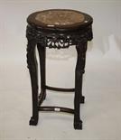 A CHINESE CHERRYWOOD JARDINIERE OR BOWL STAND,
c.1900, the circular serpentine shaped top with rouge