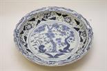 A LARGE CHINESE BLUE AND WHITE DISH, 
decorated with foliage inside a wavy rim, 23in (59cm). (1)