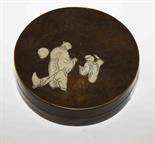 A CIRCULAR CHINESE BRONZE BASE AND COVER,
decorated with figures in a landscape 5in (12cm). (1)