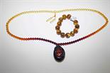 AN AMBER TYPE BEAD NECKLACE,
with pendant and a bracelet. (2)