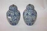 A PAIR OF CHINESE BLUE AND WHITE JARS AND COVERS, 
decorated with birds and stylized flowers, the