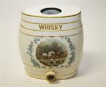 AN OVAL SHAPED PORCELAIN WHISKEY BARRELL with hunting scene in transfer, 12.75in (31cm).