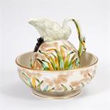 A PORCELAIN TOILET  BASIN AND EWER,
c.1900, the bulbous ewer surmounted with a swan forming the