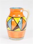 A LARGE CLARICE CLIFF BIZARRE EWER,
in orange, blue and yellow, 11in (28cm)h. (1) 
This is a