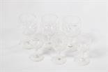 A SET OF TWELVE CUTGLASS STEMMED WINES OR BRANDY BALLOONS, 
5in (13cm); together with 11 matching