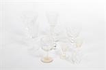 A SET OF SIX CRYSTAL CHAMPAGNE GLASSES, 
probably Waterford; together with miscellaneous liqueurs,