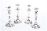 A PAIR OF ATTRACTIVE SILVER PLATED CANDLESTICKS, 
each of baluster reeded form, with leaf cast