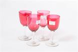 A GOOD SET OF EIGHT LATE 19TH CENTURY RUBY GLASS WINES, 
each with hexagonal baluster stem and