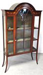 An Edwardian mahogany marquetry inlaid display cabinet, the arched door enclosing silk interior