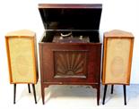 A free standing wooden music cabinet with sunburst design to the front on square tapered legs,