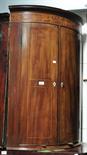 A late George III mahogany bowfront corner cupboard.
