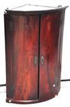 A late George III mahogany bow front hanging corner cupboard with moulded pediment.
