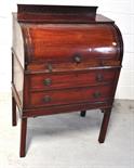 An Edwardian mahogany cylinder bureau, the sloping fall revealing a shelved interior and slide above