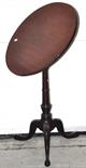 A 19th century tilt top occasional table, the circular hinged top above ring turned central column