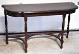 A mahogany shaped side table, length 124cm.
