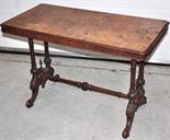 A Victorian walnut centre table raised on twin turned end supports on scrolling legs (a/f).