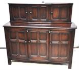 A 1930s oak priory style dining room suite comprising refectory table, six chairs (four plus two)