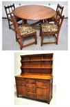 A oak dining table and four dining chairs and a modern oak dresser with drawers and cupboards to the