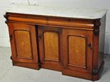 A Victorian oak and mahogany sideboard, the marble top above two frieze drawers and three invert