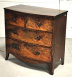 A bowfront mahogany two over two chest of drawers.