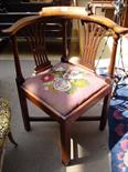 A George III mahogany corner armchair with drop in tapestry seat