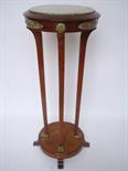 An Edwardian Empire style mahogany and ormolu mounted torchere stand.
The circular top inset with