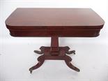 A George IV mahogany D-end fold over card table, with swivel action.
The cross banded top over