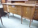 An Edwardian mahogany sideboard. Bowed central section with two short drawers and two long, flanked