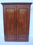 A Victorian mahogany wardrobe, the detachable projecting corbice over a pair of arched panelled
