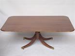 A George III style mahogany pedestal breakfast table, the rectangular tip action top with rounded