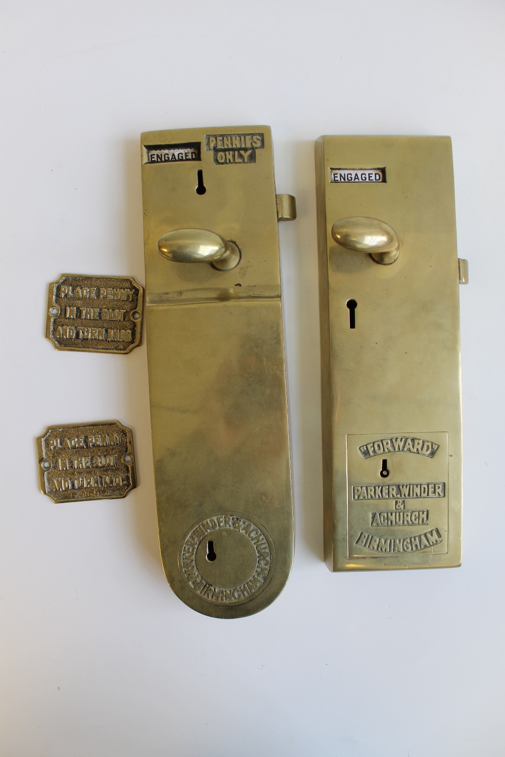 TWO BRASS `PENNY IN THE SLOT` TOILET DOOR LOCKS, by Parker, Winder & Church, Birmingham, together