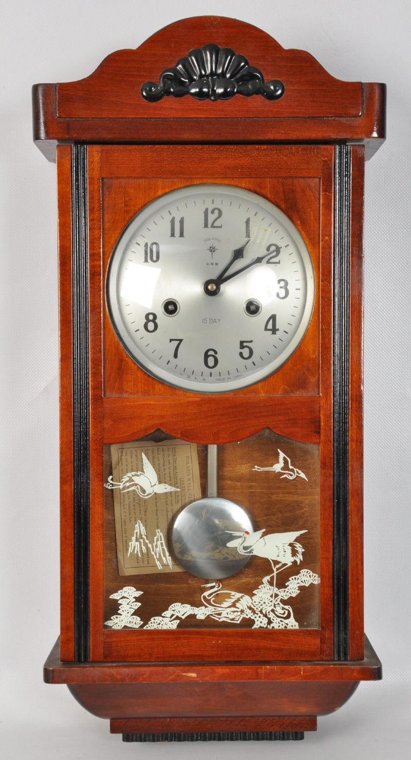 A Polaris mahoany cased wall clock having 15 day movement. 60cms High