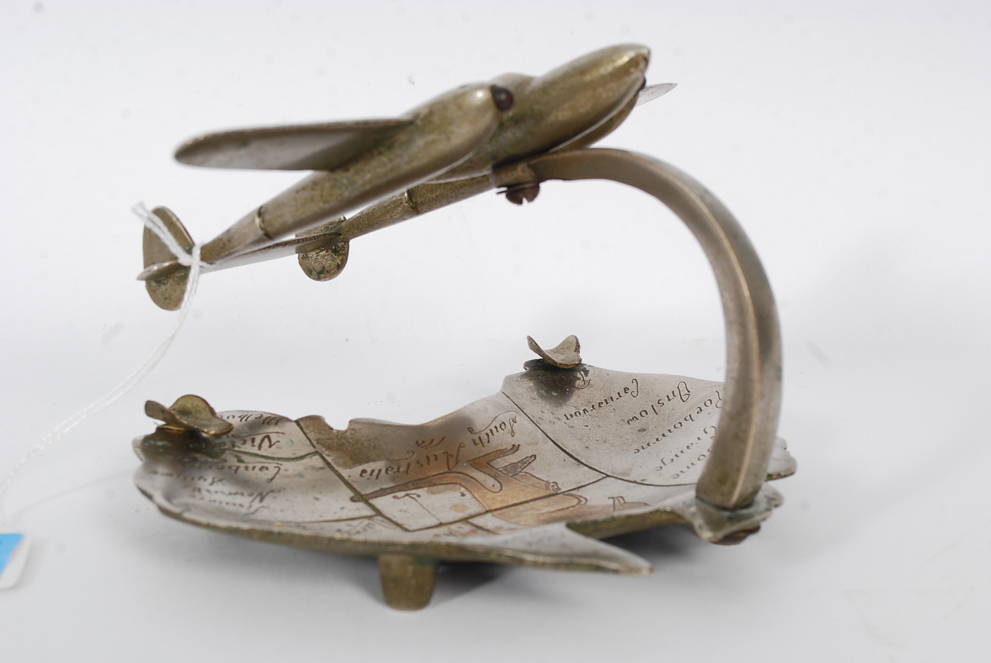 A 1940's novelty ashtray in the shape of Australia with plane flying