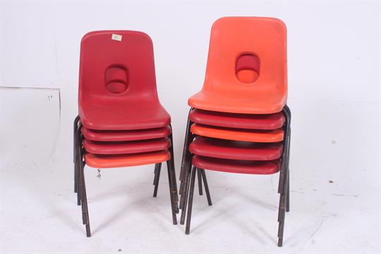a collection of 9 vintage retro hille plastic school chairs in both red and orange each supporte t49 plastic