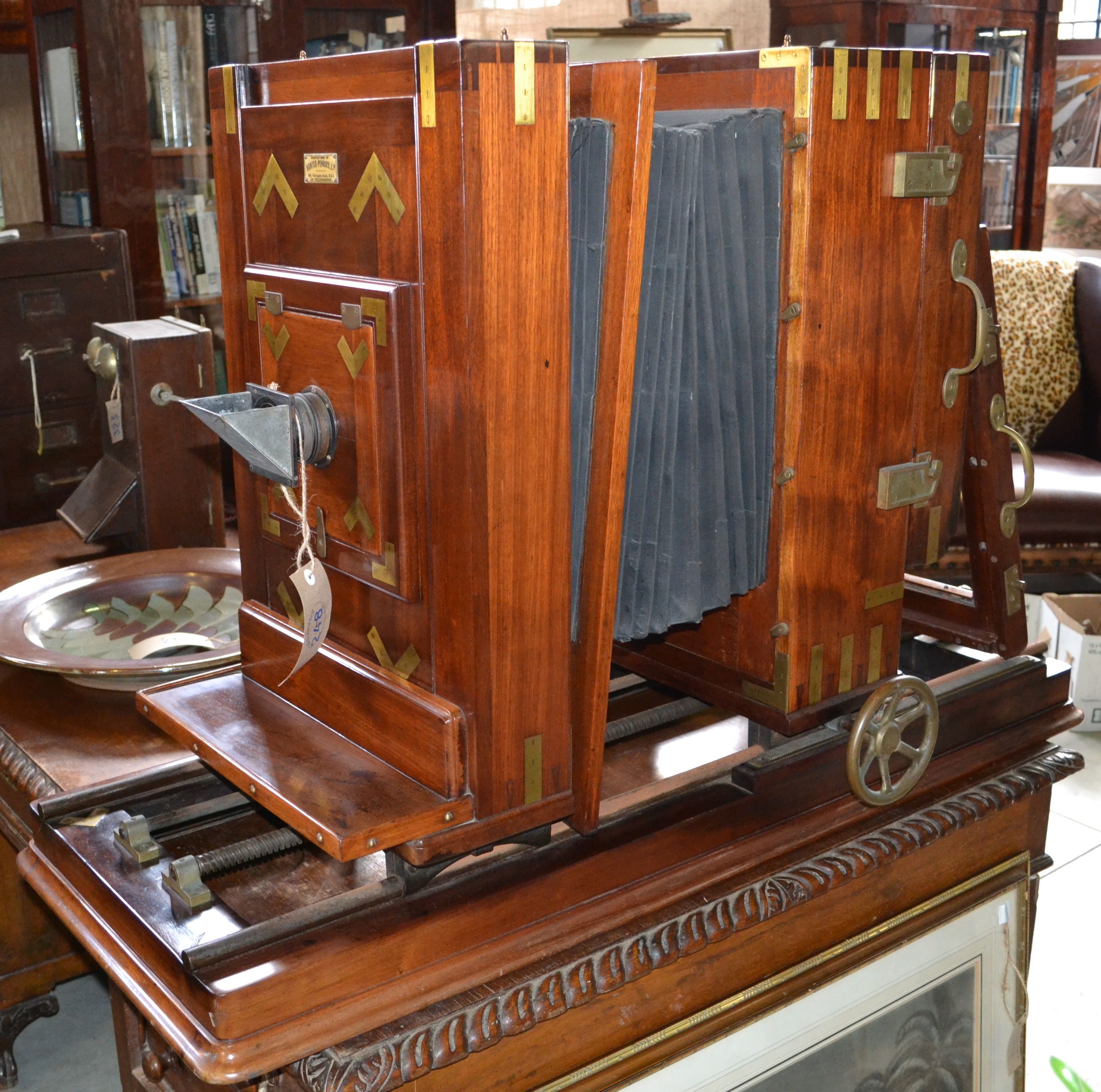 A Massive Hunter Penrose Ltd Bellow Camera In red walnut frame, on