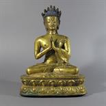 A GILT BRONZE FIGURE OF BUDDHA NAGARAJA: Tibet, c.1700 Seated in dhyanasana on a double lotus