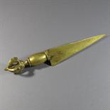 A COPPER GILT PHURBU: Tibet or Mongolia, 19th century Copper gilt, with plain, slightly concave