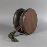 A RITUAL DRUM (DAMARU): Tibet, 19th century turned wood and hide, with red felt band clasped with a