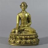 A GILT-BRONZE FIGURE OF A LAMA: Tibet, 16th century seated on a double lotus throne, his hands in