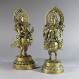A PAIR OF KINNARAS : Nepal, c.1900 Cast brass, the two half bird, half human deities standing on