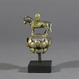 A PARCEL GILT FIGURE OF LUNGTA: Tibet, 18th/19th century standing on a lotus with cintamani on his