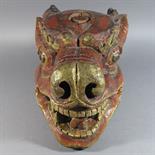 A POLYCHROME PAINTED WOOD MASK: Tibet, 19th century In the form of a fierce boar, with gaping jaws,