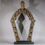 A CARVED AND PAINTED WOOD PRABHA: Tibet, 18th century Of horseshoe form, the sides decorated with